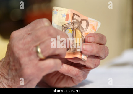 Berlin, Germany, the hands of a pensioner with a Euro bill Stock Photo