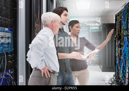 Business people working in server room Stock Photo