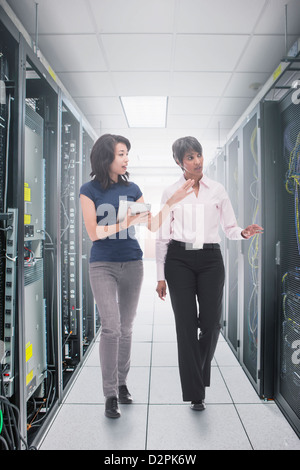 Businessmen working in server room Stock Photo