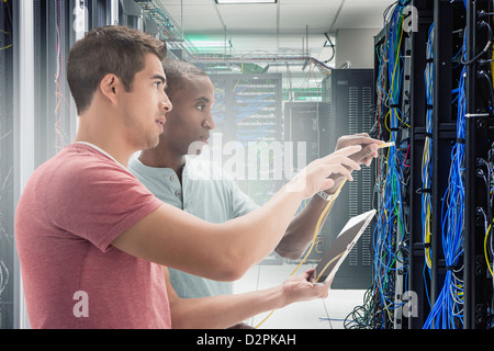 Businessmen working in server room Stock Photo