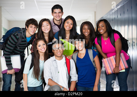 High school friends standing in corridor together Stock Photo