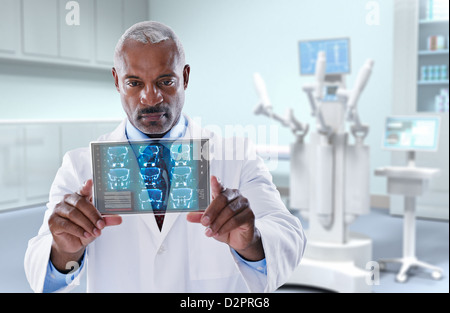 Black doctor looking at digital tablet Stock Photo