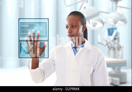 African American doctor looking at digital display in doctor's office Stock Photo