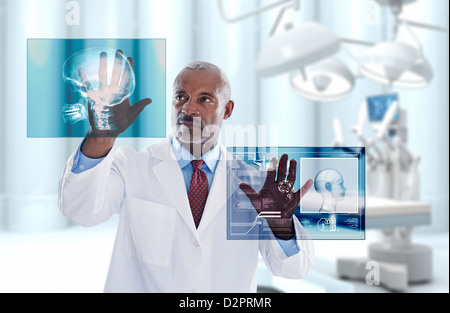 Black doctor looking at digital display in doctor's office Stock Photo