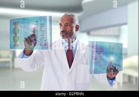 Black doctor using digital display in doctor's office Stock Photo