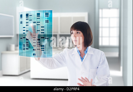 Mixed race doctor using digital display in doctor's office Stock Photo