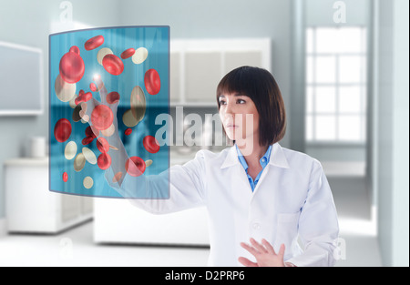 Mixed race doctor using digital display in doctor's office Stock Photo