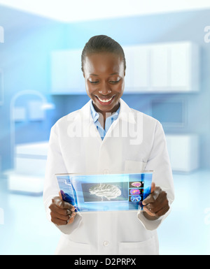 African American doctor using digital tablet in doctor's office Stock Photo