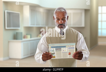 Black businessman using digital tablet in office Stock Photo