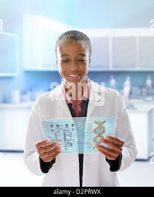 Black doctor using digital tablet in doctor's office Stock Photo