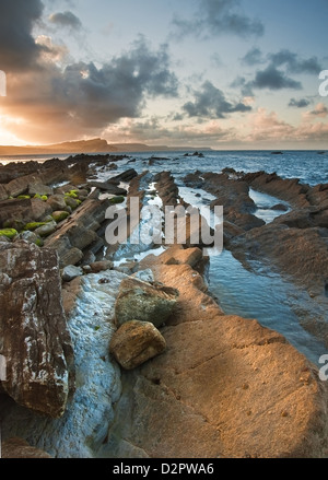 Beautiful sunrise landscape over Mupe Bay on Jurassic Coast in Dorset, England Stock Photo