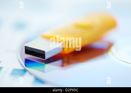 Macro view of a flash-driver and a cd captured with selective focus Stock Photo