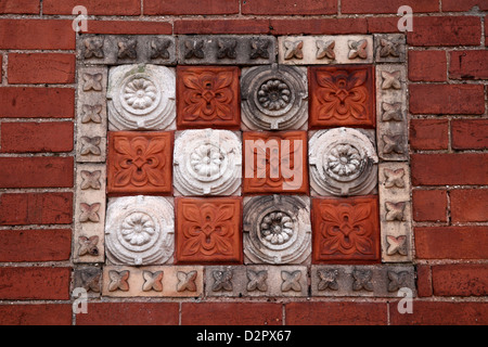 Decorative floral and fruit brick and stone frieze - Exmouth, Devon, UK Stock Photo