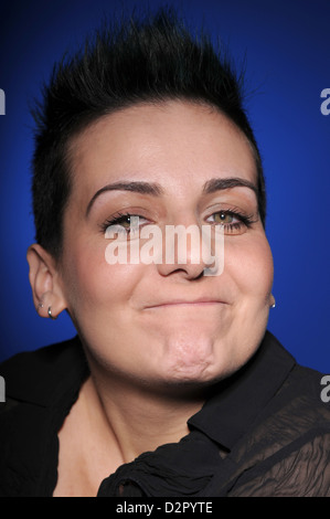 A young brunette woman makes facial expression Stock Photo