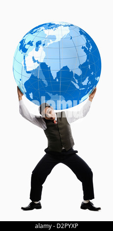 Businessman balancing a globe over his shoulders Stock Photo