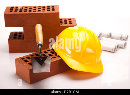 Construction plans and blueprints, bricks, hard hat Stock Photo