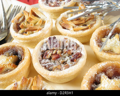 Mini mince pies with a variety of toppings. Stock Photo