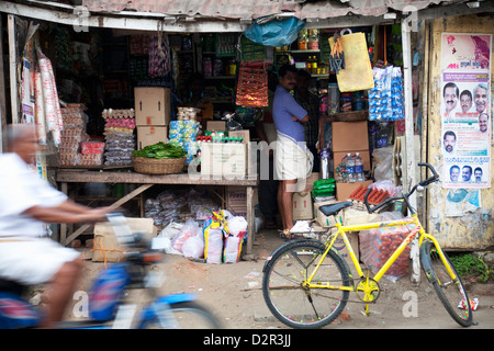 Motorcycle passing a shop in Thekkady, Kerala, India, Asia Stock Photo