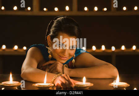Woman decorating oil lamps in Diwali festival Stock Photo