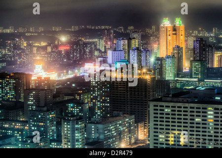 New modern buildings in the centre of Pyongyang colourfully illuminated at night, Pyongyang, North Korea Stock Photo