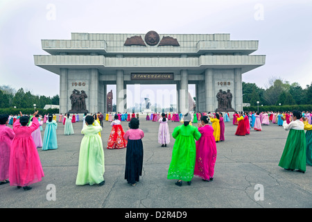 Women in colourful traditional dresses at mass dancing, Pyongyang, North Korea Stock Photo