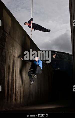 Parkour runners in alley, London, UK Stock Photo