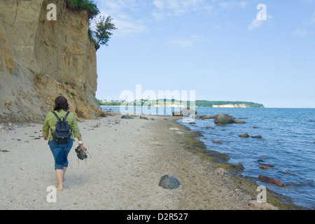 Woman on the beach with cliff Stock Photo