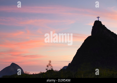 Christ the Redeemer statue (Cristo Redentor) at sunset, Corvocado, Rio de Janeiro, Brazil, South America