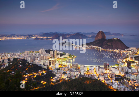 View of Sugar Loaf Mountain (Pao de Acucar) and Botafogo Bay at dusk, Rio de Janeiro, Brazil, South America Stock Photo