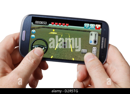 Playing a game on a mobile phone smartphone smart phone Stock Photo