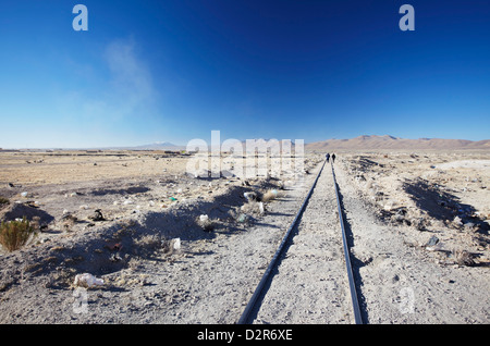 People walking along train tracks, Uyuni, Potosi Department, Bolivia, South America Stock Photo