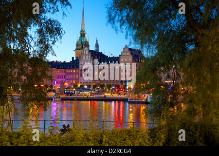 Gamla Stan and Riddarholmen with spire of Riddarholmskyrkan (Riddarholmen Church) at dusk, Stockholm, Sweden Stock Photo