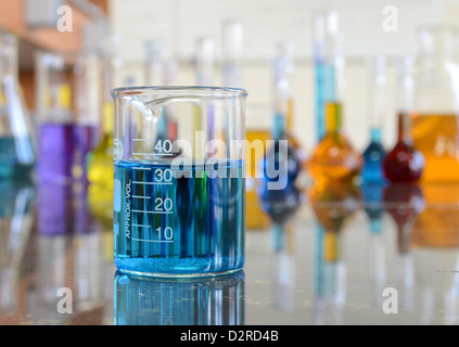 Volumetric flask with orange solution Stock Photo - Alamy