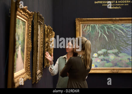 London, UK. 31 January 2013.  Visitors stand in front of paintings during the press preview of the forthcoming Sotheby's February sales of Impressionist & Modern Art and Contemporary Art in London, including works by Picasso, Bacon, Monet, Richter, Miró, Basquiat. Credit:  pcruciatti / Alamy Live News Stock Photo