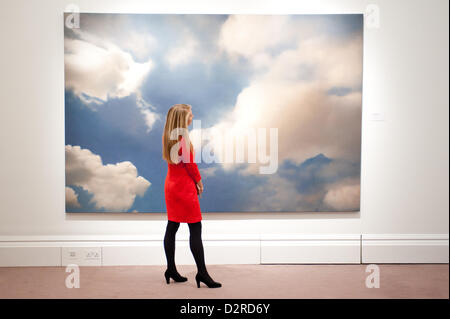 London, UK. 31 January 2013.  A Sotheby's employee poses in front of a painting 1976 entitled 'Wolke (Cloud)' by Gerhard Richter (Est. £7-9 million) during the press preview of the forthcoming Sotheby's February sales of Impressionist & Modern Art and Contemporary Art in London, including works by Picasso, Bacon, Monet, Richter, Miró, Basquiat. Credit:  pcruciatti / Alamy Live News