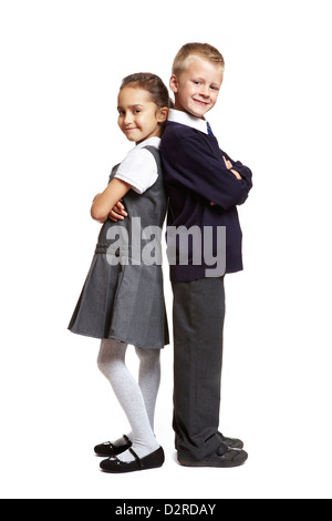 8 year old boy girl stood back to back on white background Stock Photo ...