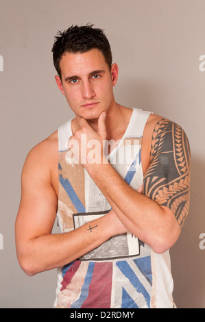 Attractive handsome hunky young man in singlet vest. Stock Photo