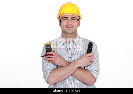 Electrician with voltmeter and clippers Stock Photo