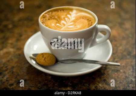 Horizontal close up of a cappuccino coffee with rosetta pattern inside Bewley's Oriental Cafe in Dublin. Stock Photo