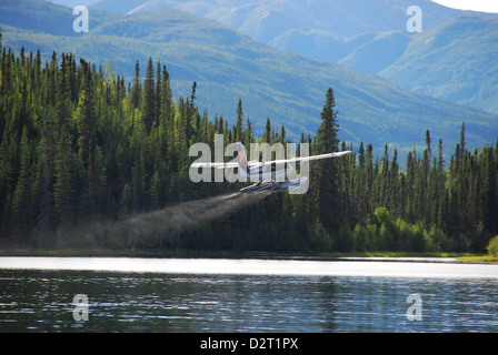 Float plane taking off from Haywire Lake in the Northwest Territories of Canada. Stock Photo