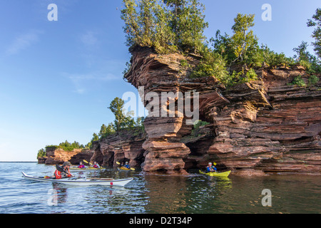 Kayakers exploring the sea caves of Devils Island in the Apostle Islands National Lakeshore, Wisconsin, USA (MR) Stock Photo