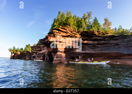 Kayakers exploring the sea caves of Devils Island in the Apostle Islands National Lakeshore, Wisconsin, USA (MR) Stock Photo