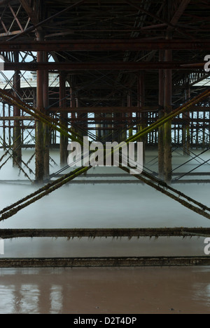 Underneath Cromer Pier, waves with a long exposure time, in Norfolk, England Stock Photo