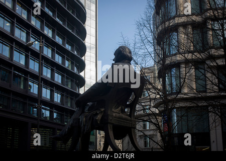 The rear of the statue of George Peabody and modern offices in the heart of the financial City of London. Peabody was a philanthropist, banker and entrepreneur George Peabody (1795 to 1869). The three men each concentrate on their own communications, all separated by a suitable personal space to maintain their privacy. The pavement is a pedestrian area near the Bank of England and adjacent to the 3rd Royal Exchange built in 1842 by Sir William Tite. Stock Photo