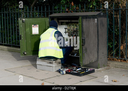 BT engineer working at an open street cabinet. Stock Photo