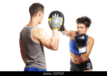 Young man and woman boxing sparring in sports outfits on white background Stock Photo