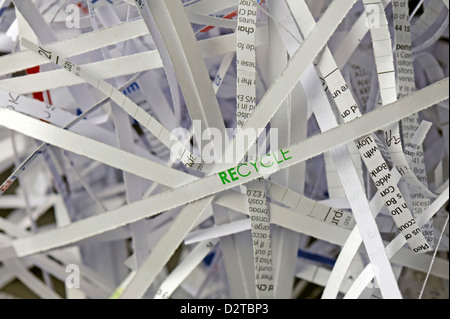Close-up of shredded paper with the focus on the word "RECYCLE" Stock Photo