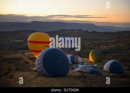 Hot air balloons being inflated and taking off at dawn in Cappadocia Turkey Stock Photo