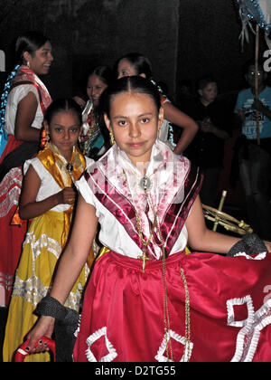 colorful procession in Oaxaca de Juarez, Mexico on the night of January 31st, 2013, celebrates Our Lady of the Candles; Nuestra Señora de la Candelaria. Two young Mexican girls show off their vibrant costumes. Stock Photo