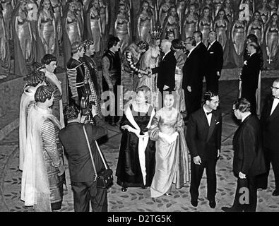 King Bhumibol and Queen Sirikit with Wilhelmine Lübke (M) , the wife of german president Lübke, ath the Wagner festival in Bayreuth, Germany, on 1 August 1960. In the background: German president Heinrich Lübke is greeting the perfoming artists. Stock Photo